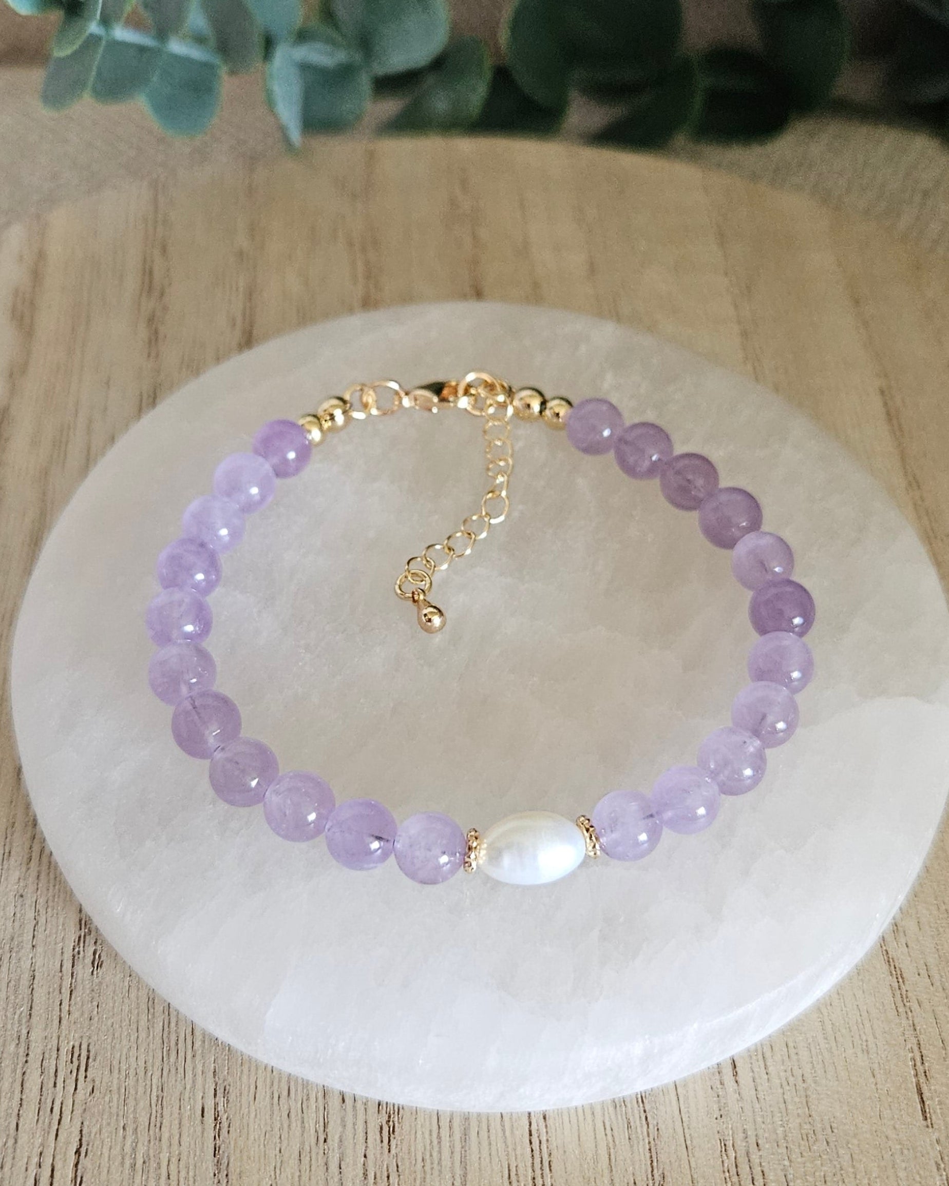 Light purple amethyst bracelet with freshwater pearl on selenite plate