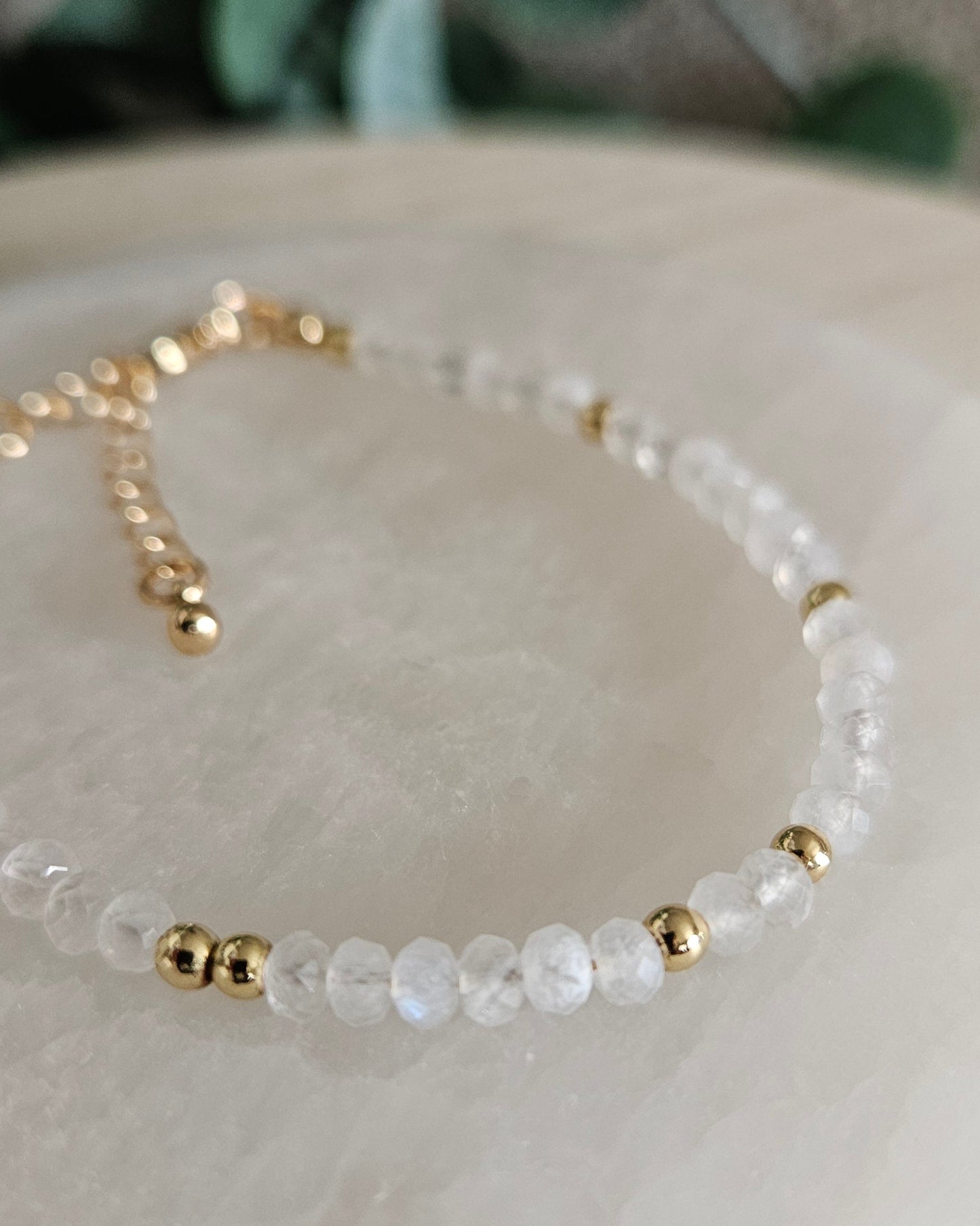 Close-up of the translucent faceted Moonstone beads and polished gold-plated spacer accents