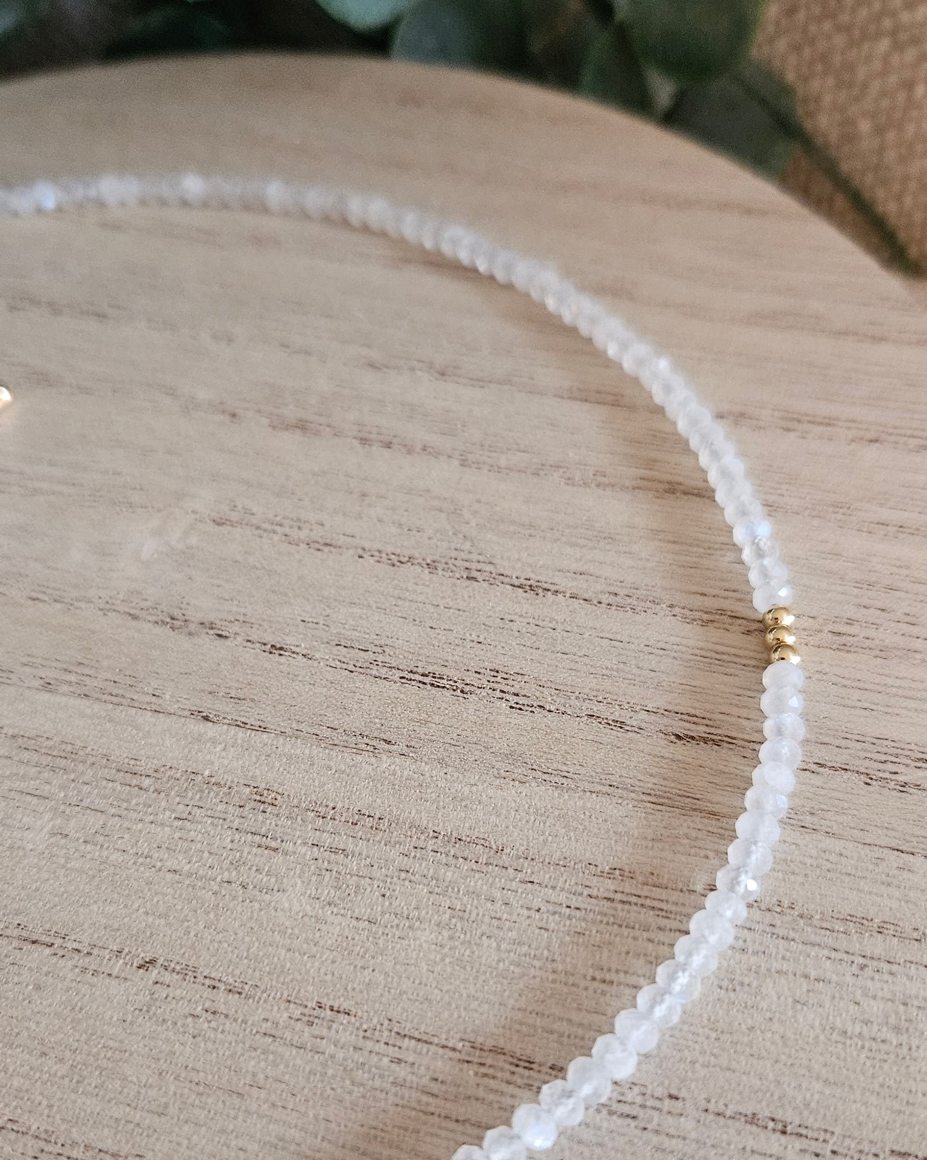 Close-up of the Moonstone necklace showing its faceted beads and gold-plated spacer detail