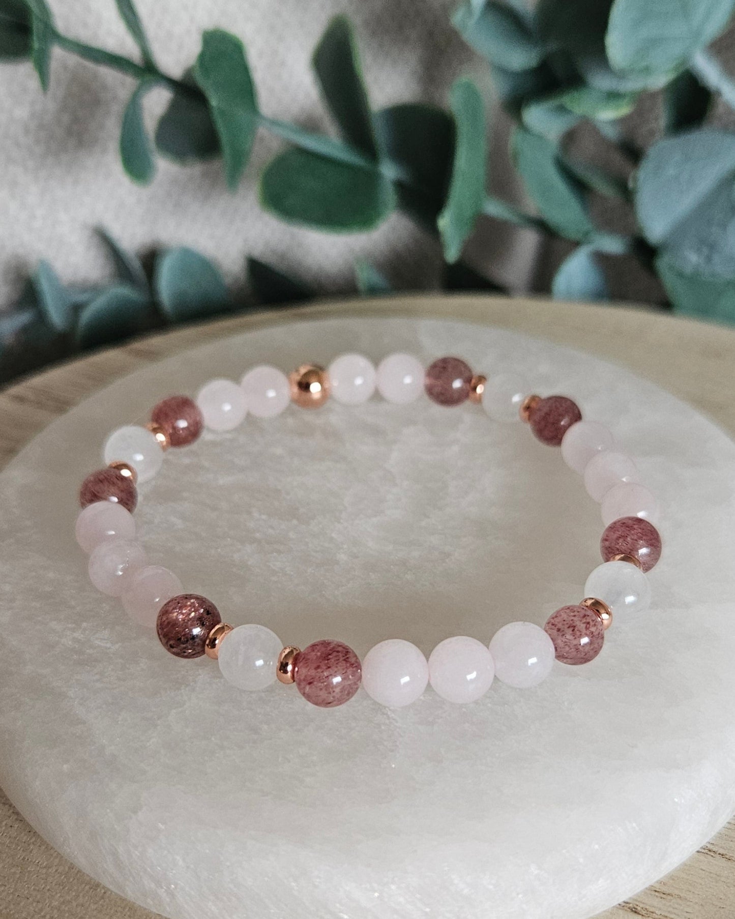 Detailed view of Strawberry Quartz, Moonstone and Rose Quartz beads with rose gold-plated spacers