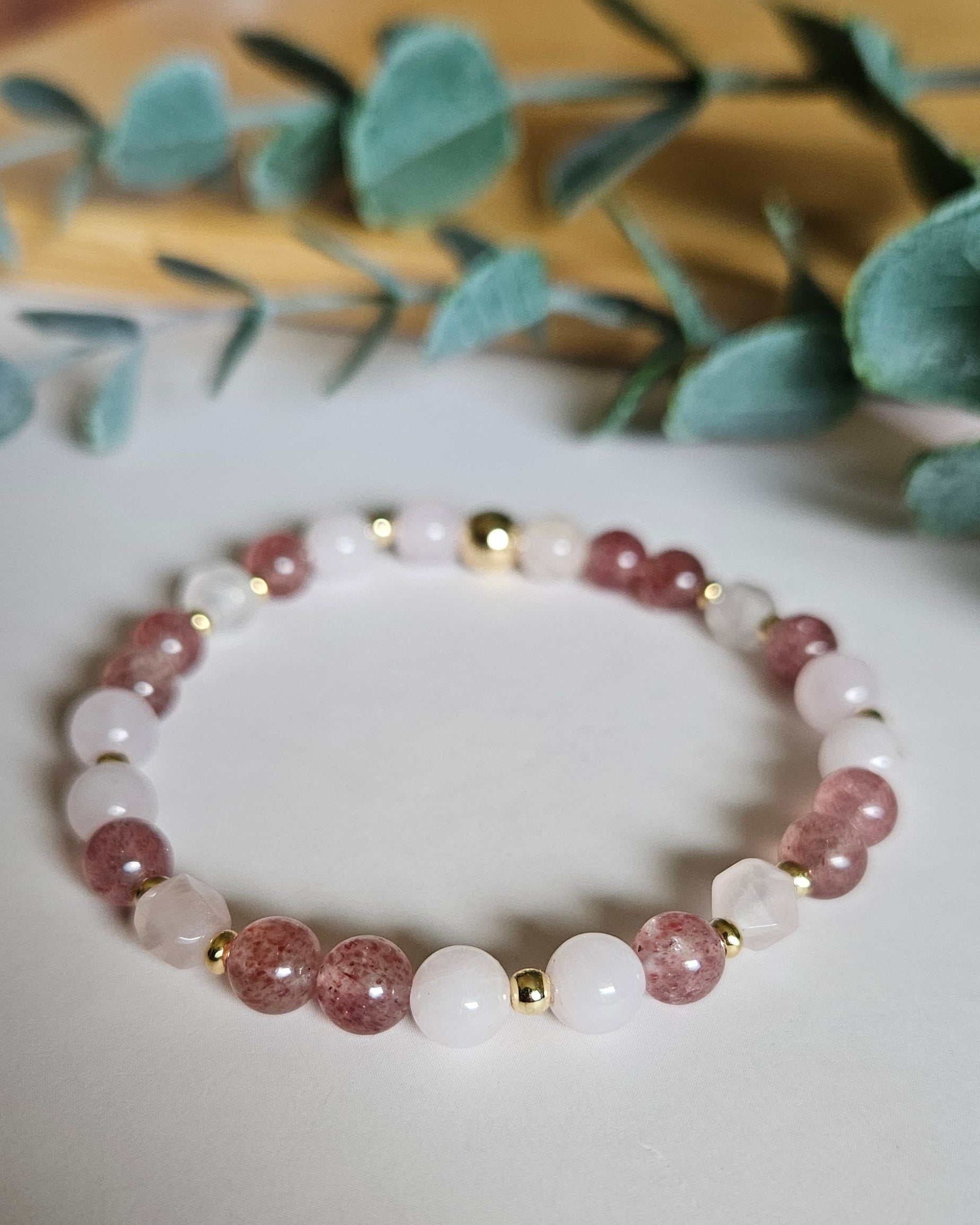 Rose Quartz and Strawberry Quartz bracelet with gold accents inspiring love, compassion, and emotional healing