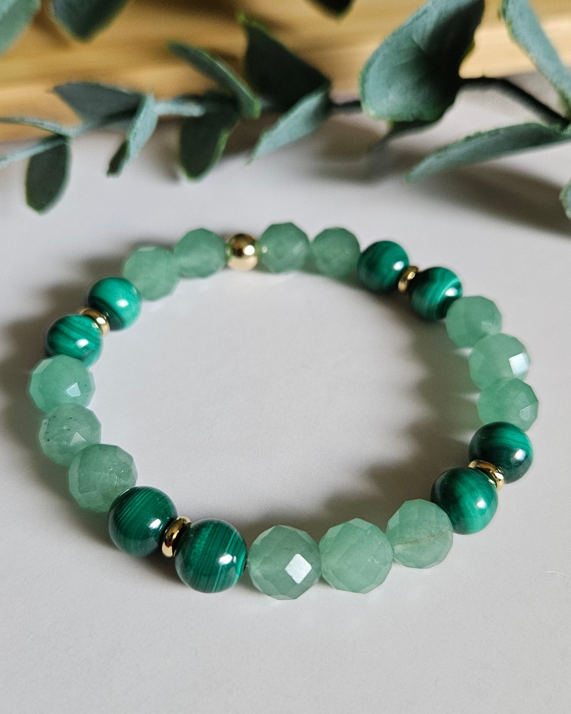 Green Aventurine and Malachite bracelet with gold accents symbolizing growth, transformation, and courage