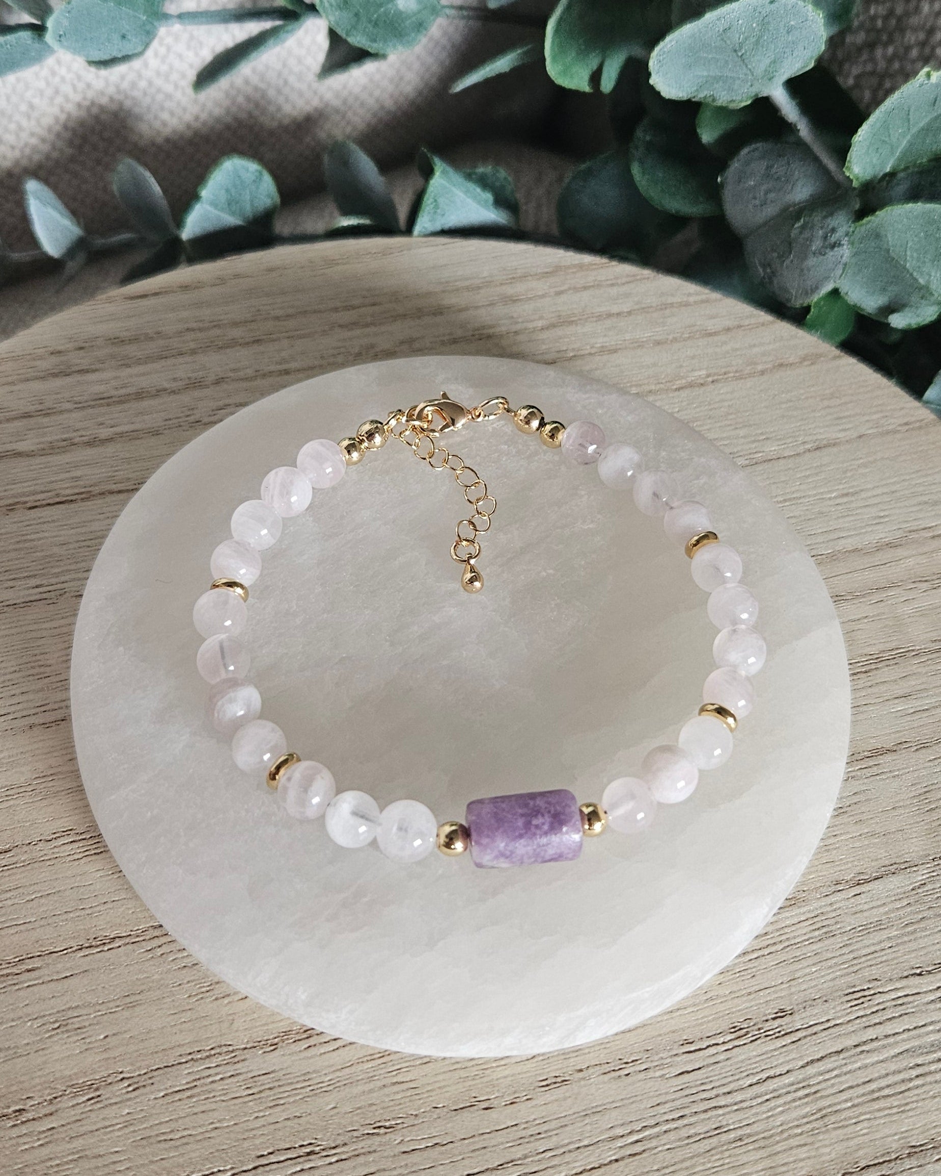 Overhead view of the Rose Quartz and Lepidolite bracelet with its clasp, extender chain and cubic zirconia charm