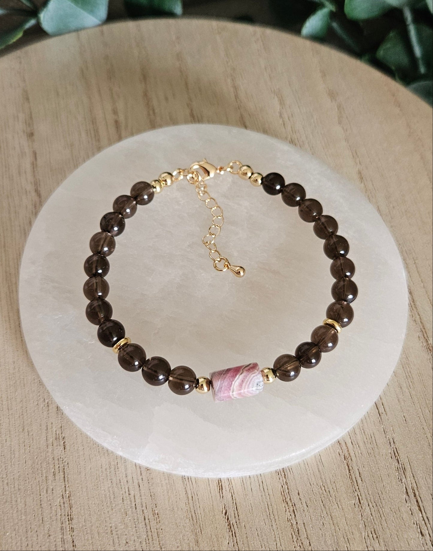 Overhead view of the Smoky Quartz and Rhodochrosite bracelet with gold clasp and extender chain
