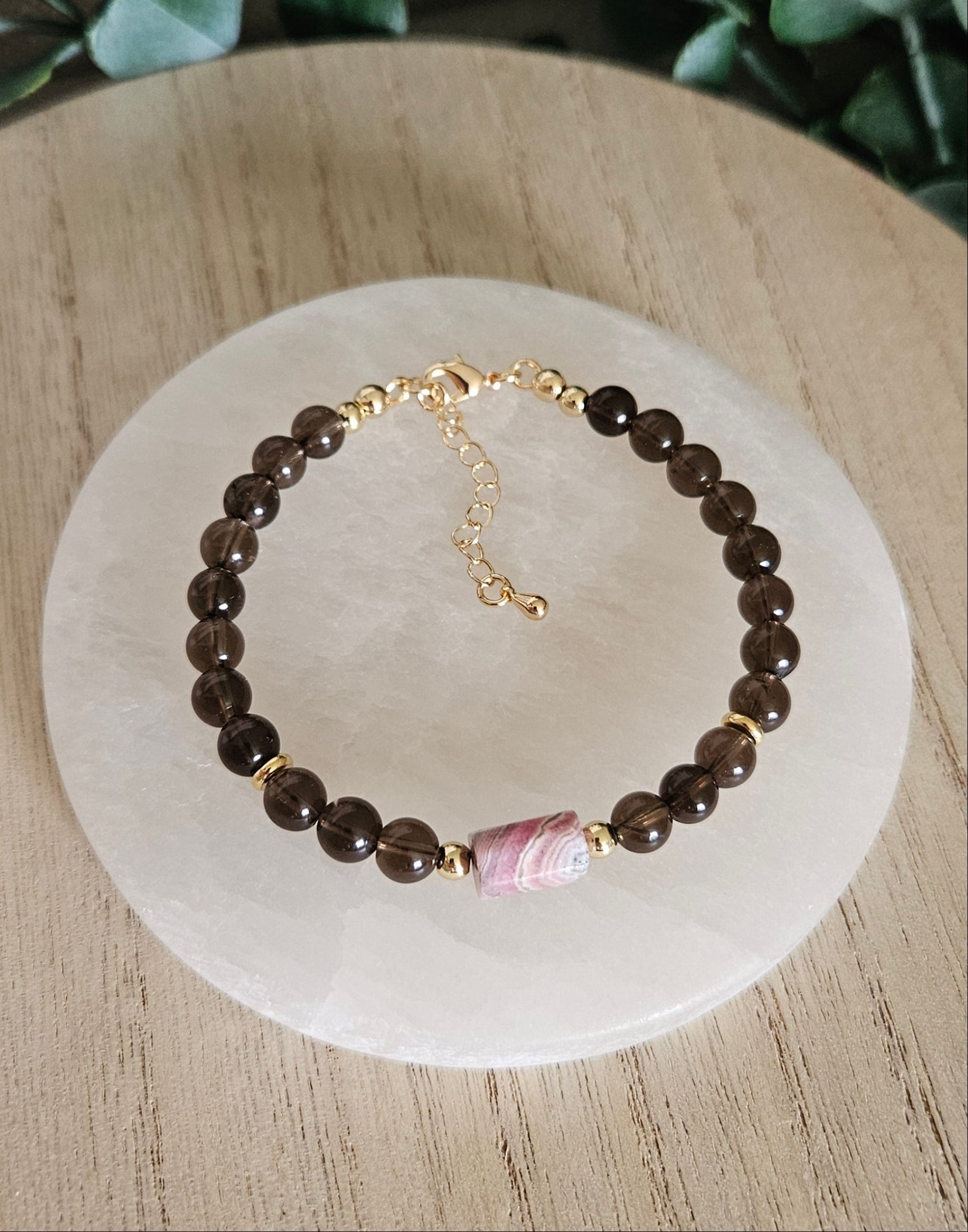 Overhead view of the Smoky Quartz and Rhodochrosite bracelet with gold clasp and extender chain