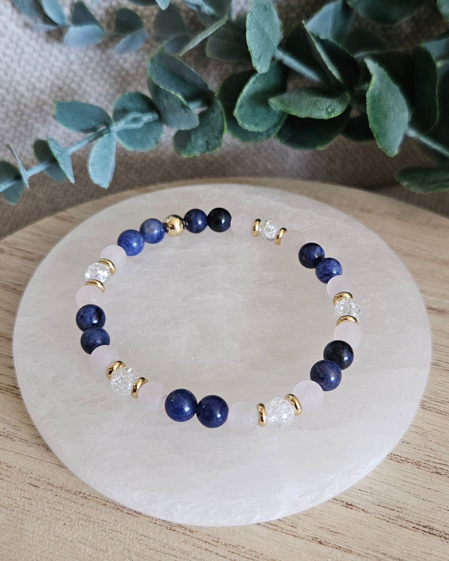 Overhead view of the Sodalite, Rose Quartz and cracked Clear Quartz bracelet with gold-plated accents
