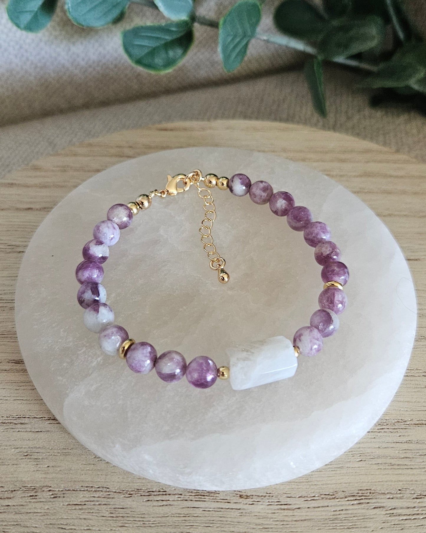 Overhead view of the purple Lepidolite and Moonstone bracelet with gold clasp and extender chain