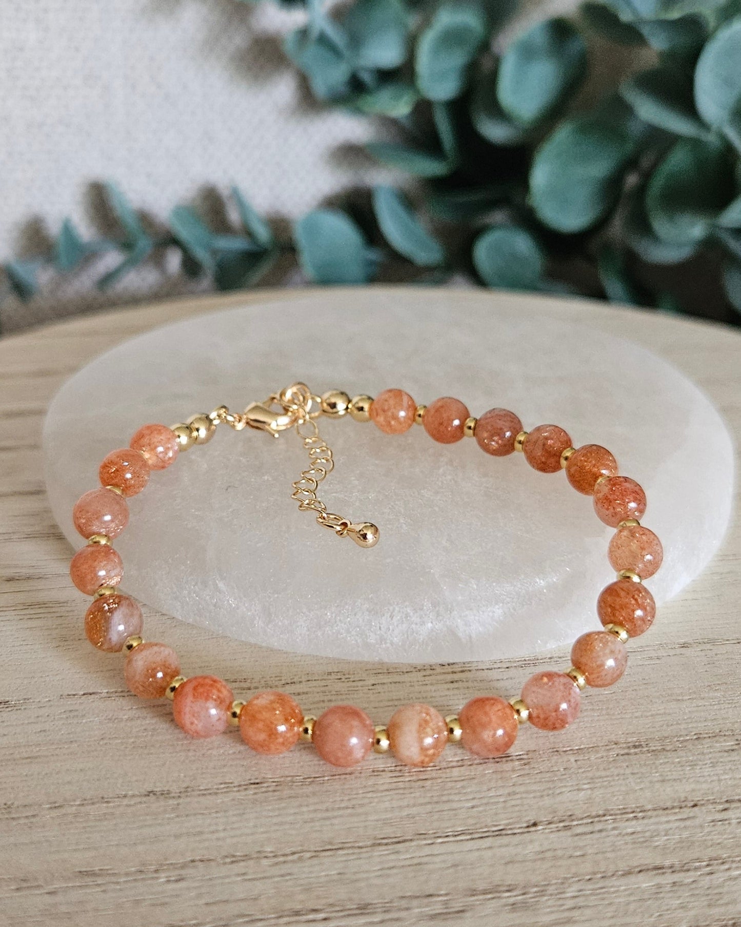 sunstone bracelet with greenery in the background