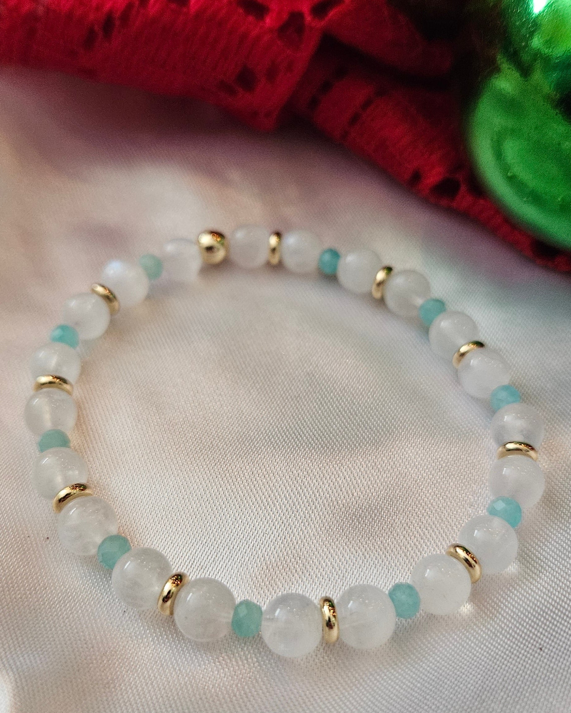 Bracelet with white and gold beads on a white background