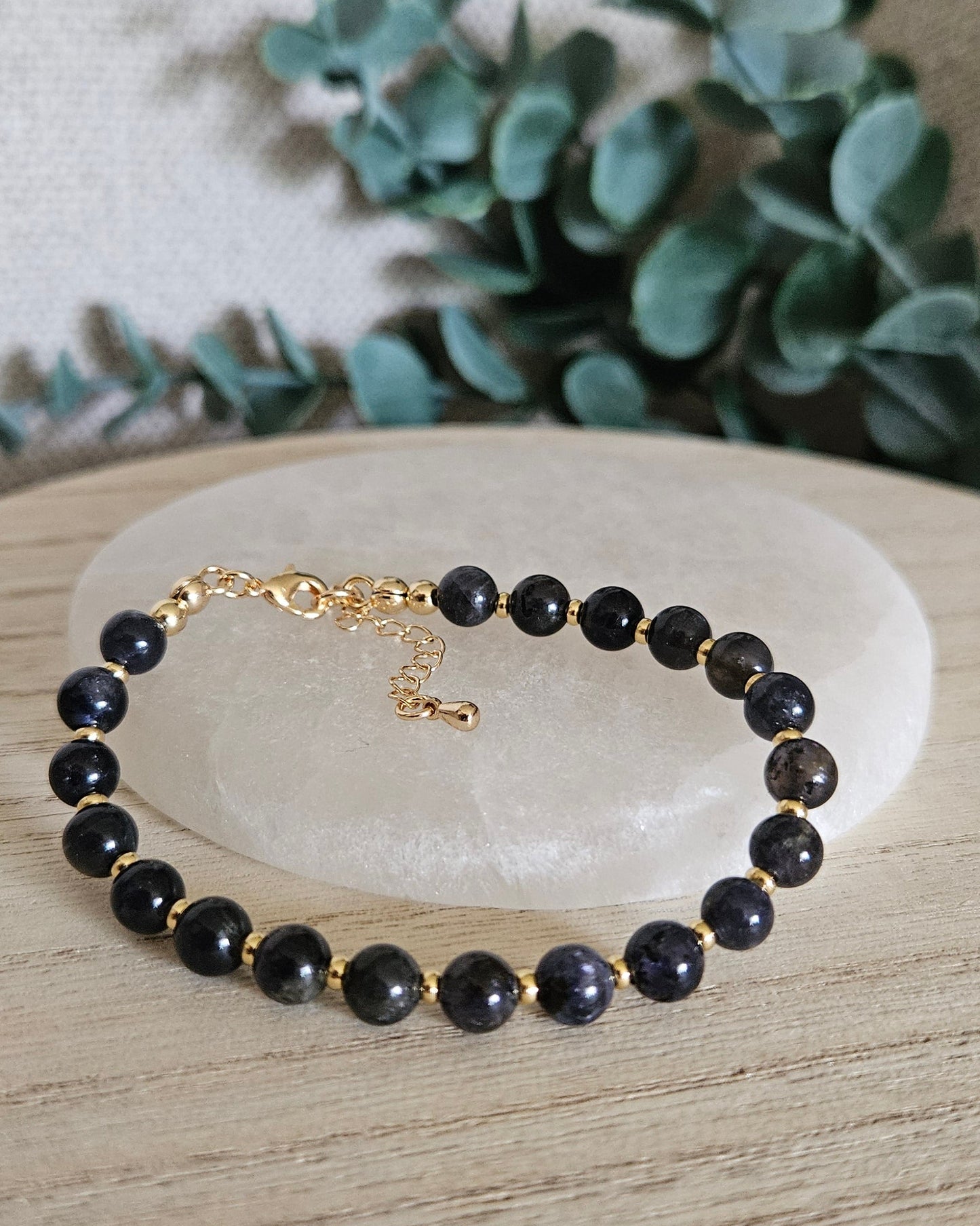 iolite bracelet with greenery in the background
