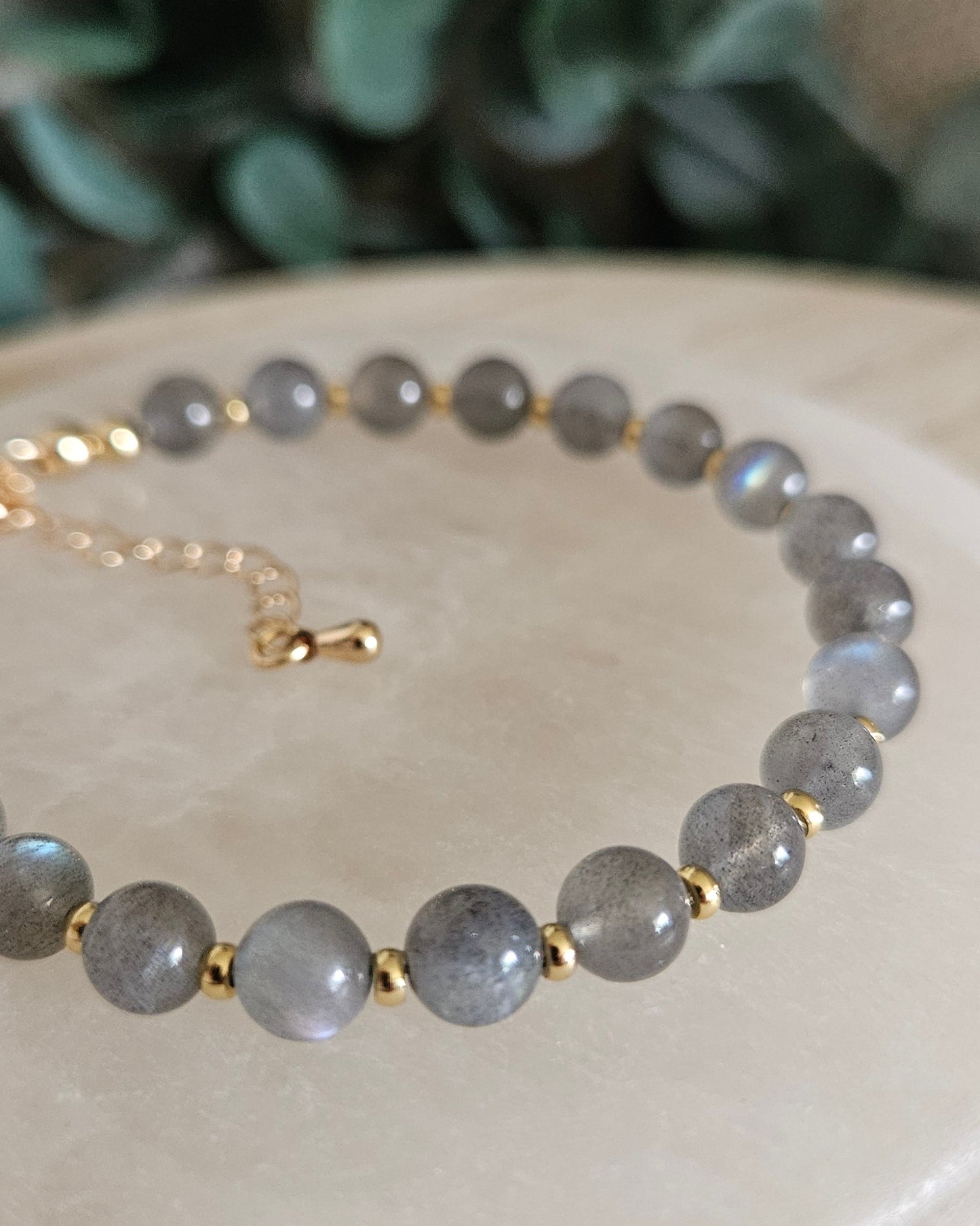 gray bracelet with gold accents
