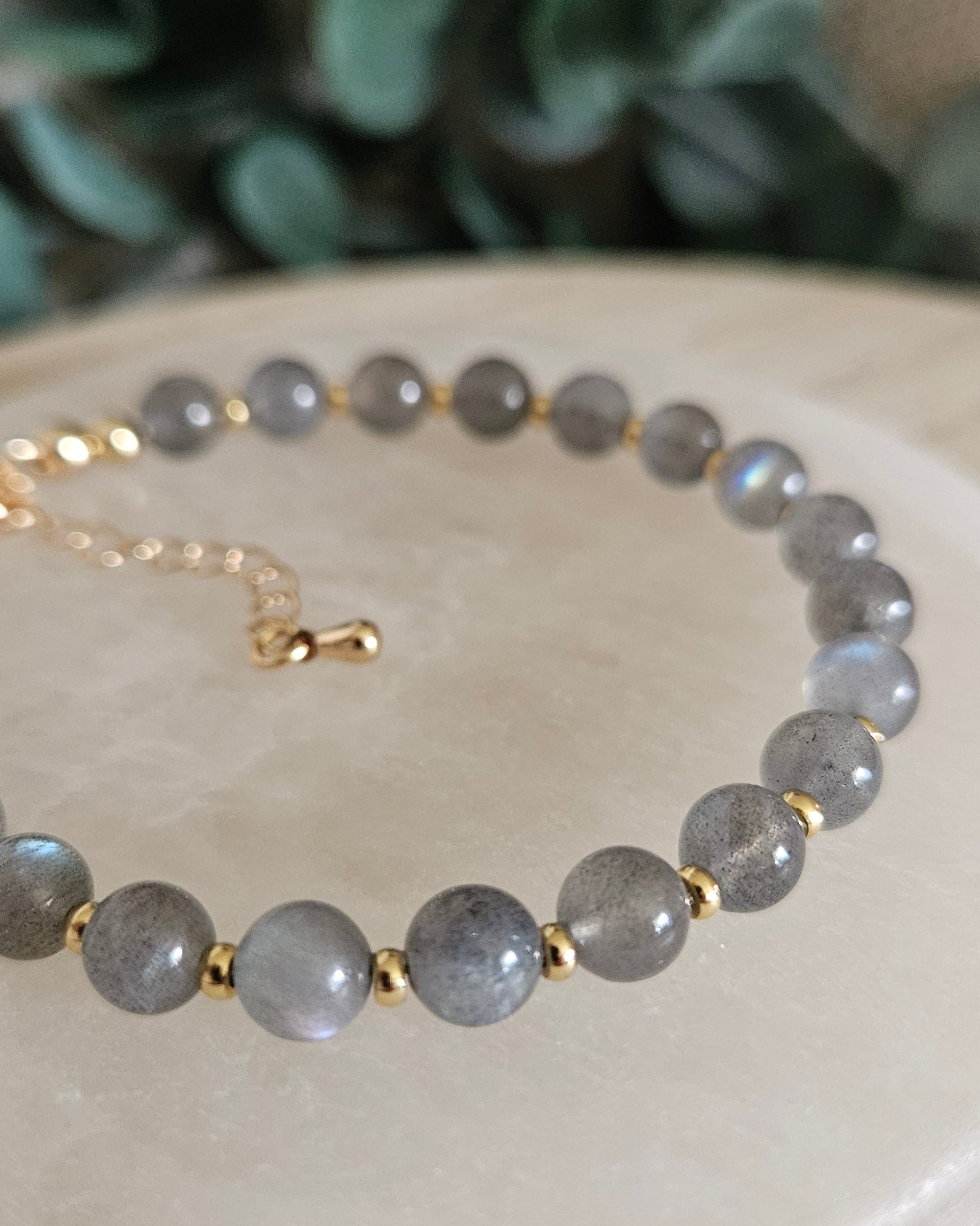 gray bracelet with gold accents