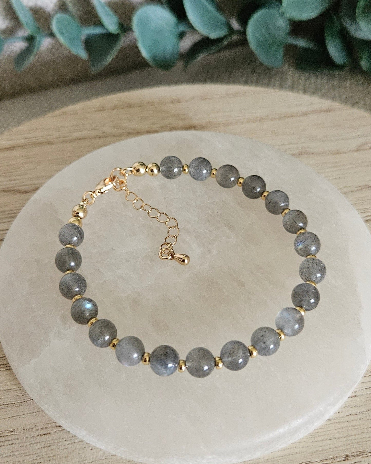 gray bracelet on selenite plate
