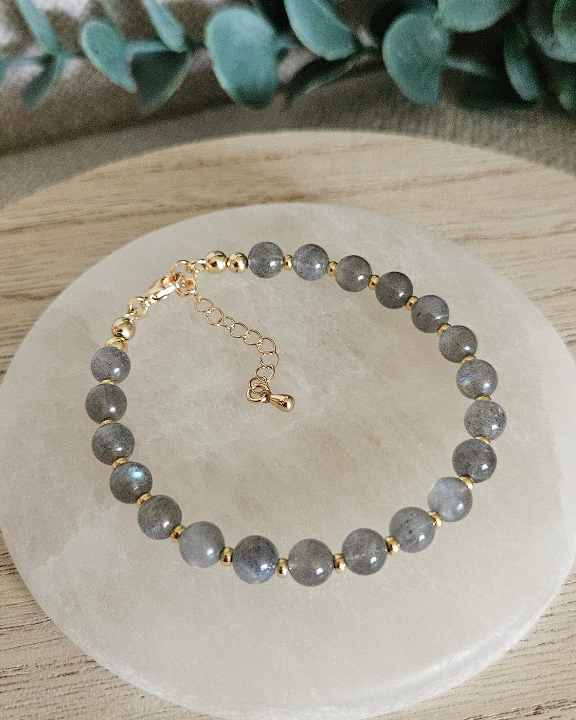gray bracelet on selenite plate