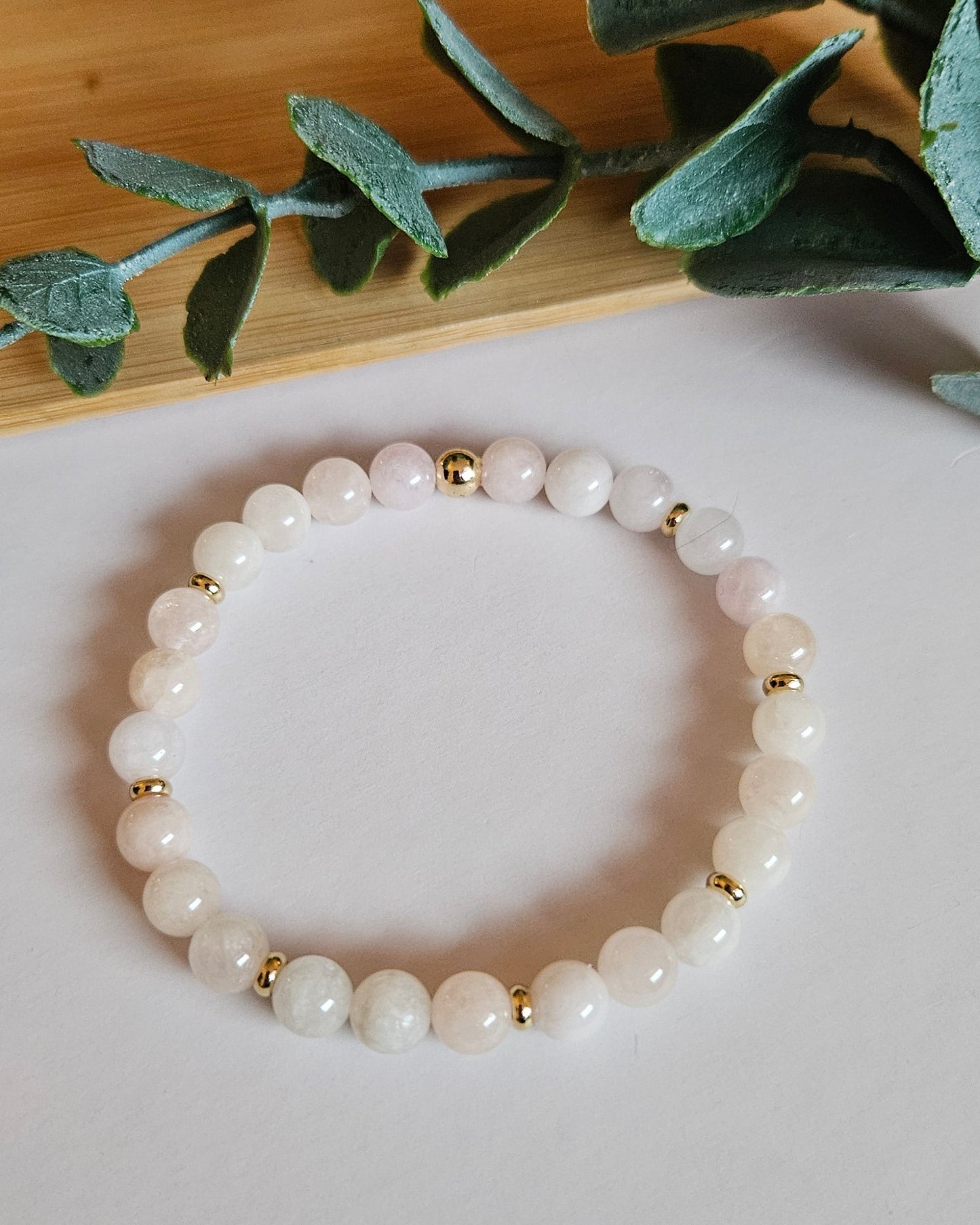 pink beaded bracelet with gold accents