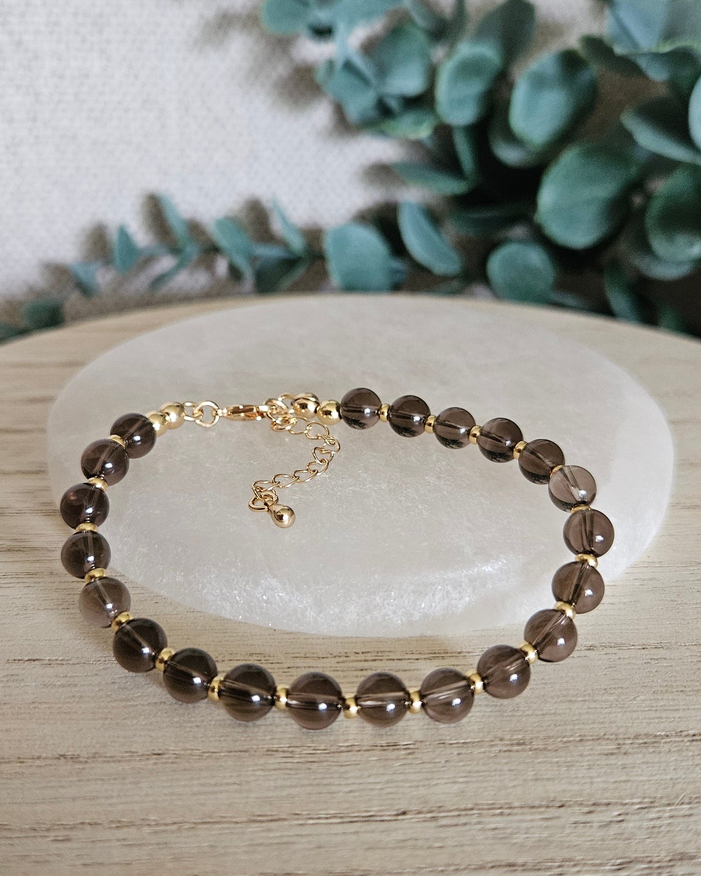brown bracelet gold accents on selenite plate